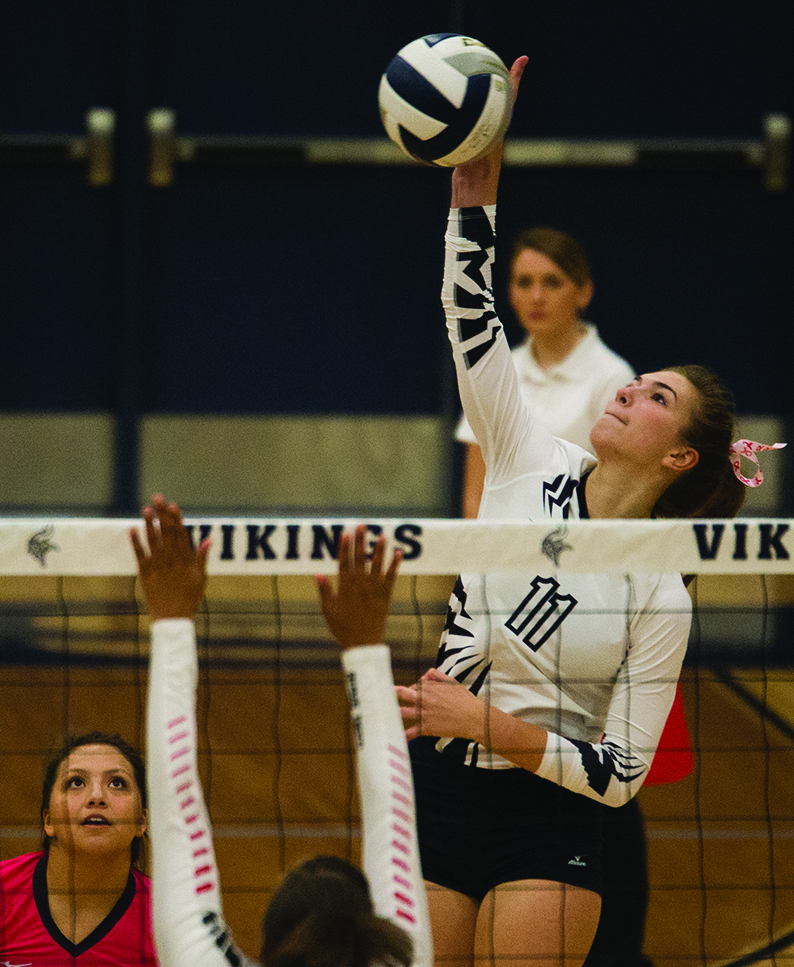 2017 senior Emily Hubacek reaches over the Waco block for a kill.